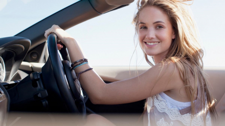 Portrait-of-smiling-woman-driving-convertible.jpg